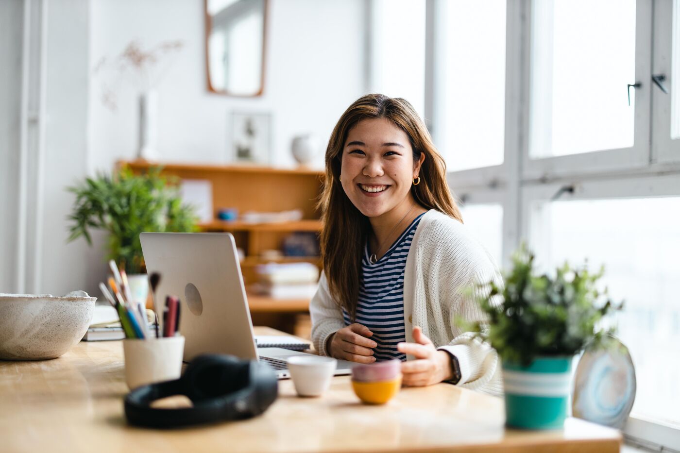 Young woman sitting at desk working on laptop