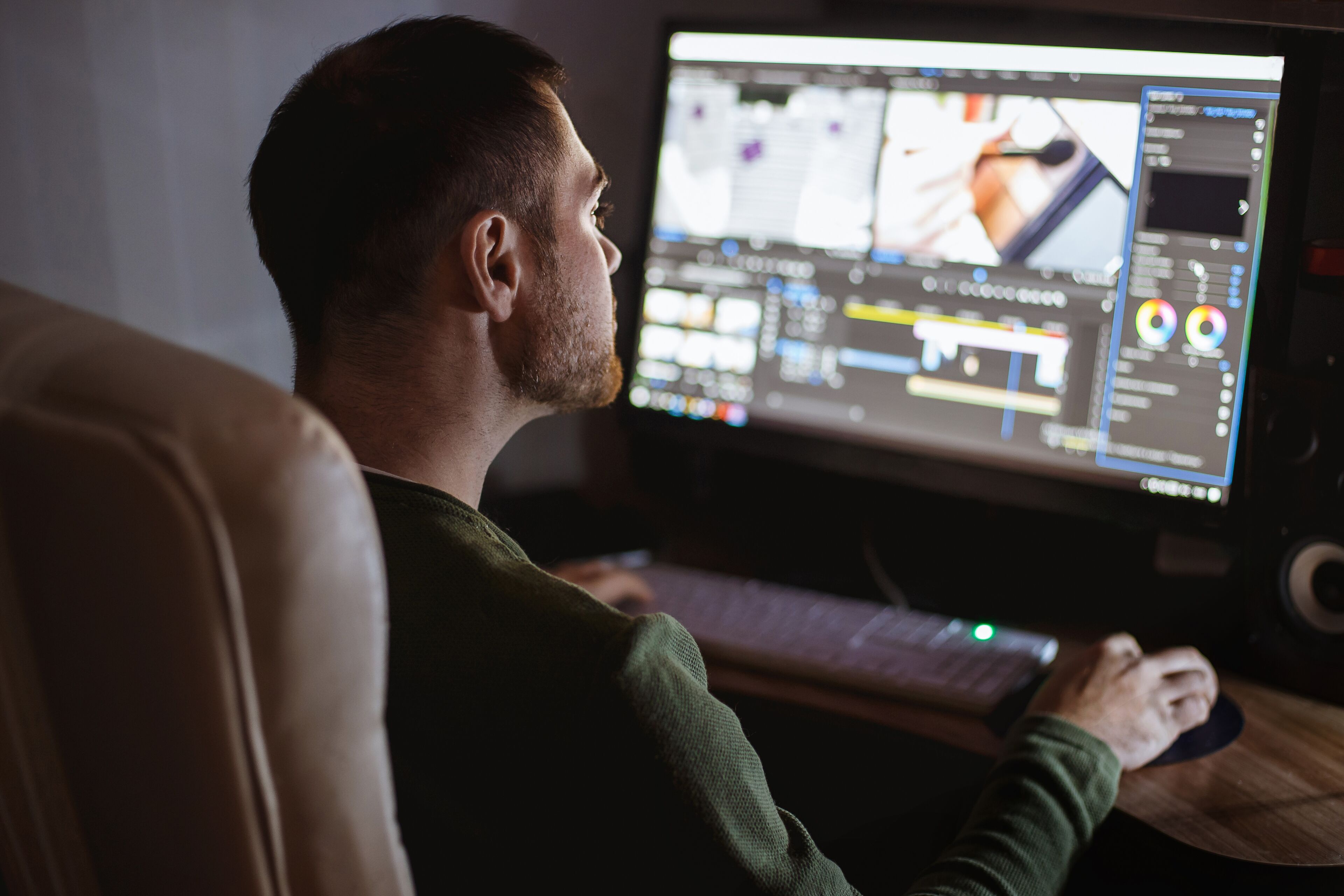 A video editor edits a video on a home workstation.