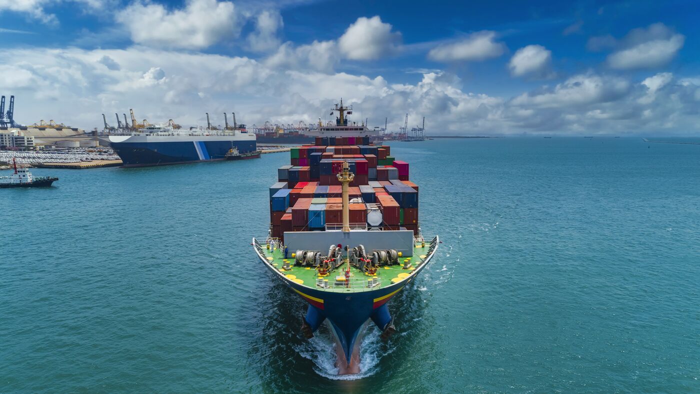 Cargo Ship Navigating Busy Port