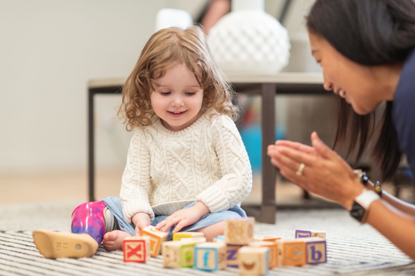 Toddler Engaged in Play with Alphabet Blocks