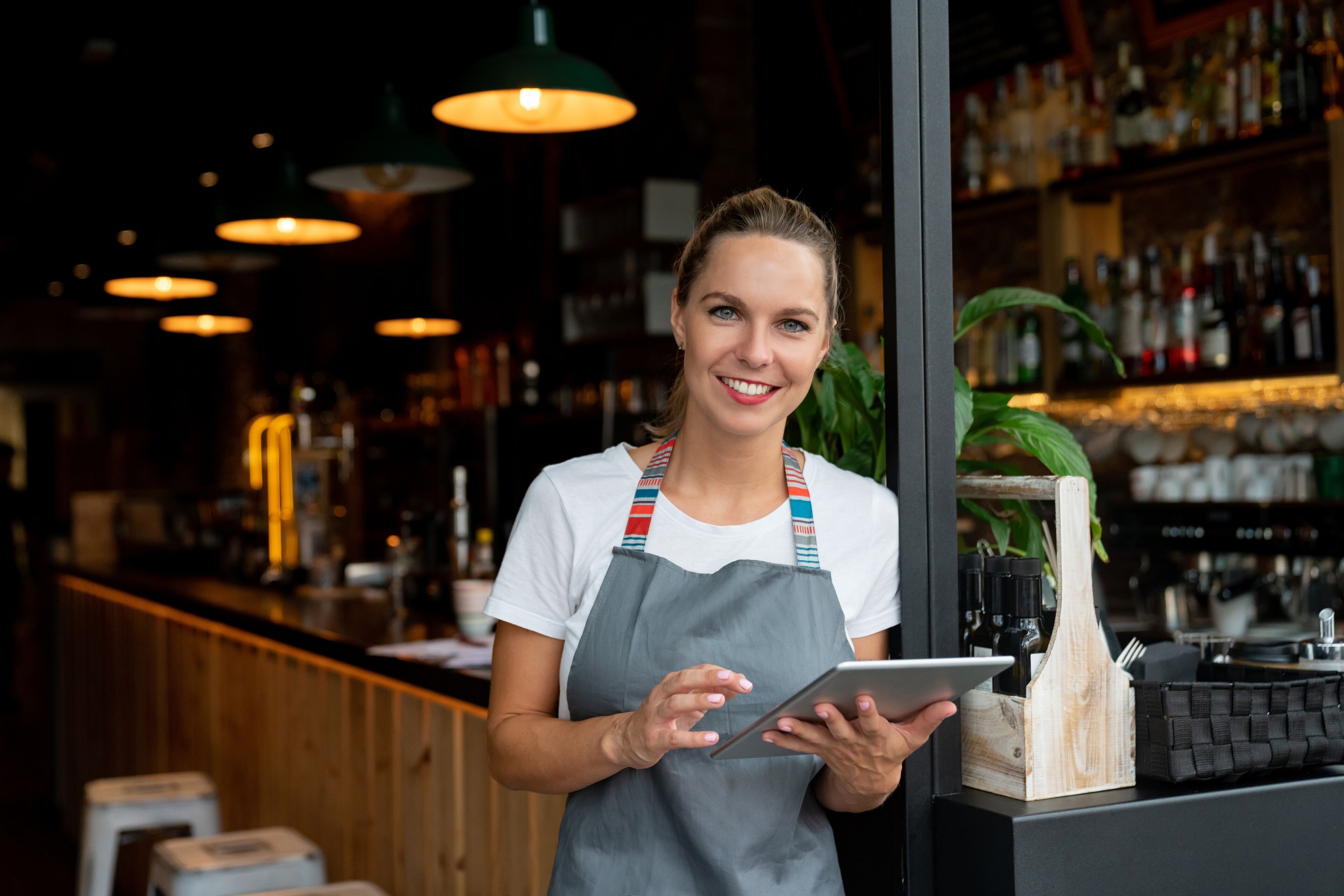 Confident Restaurant Owner with Digital Tablet