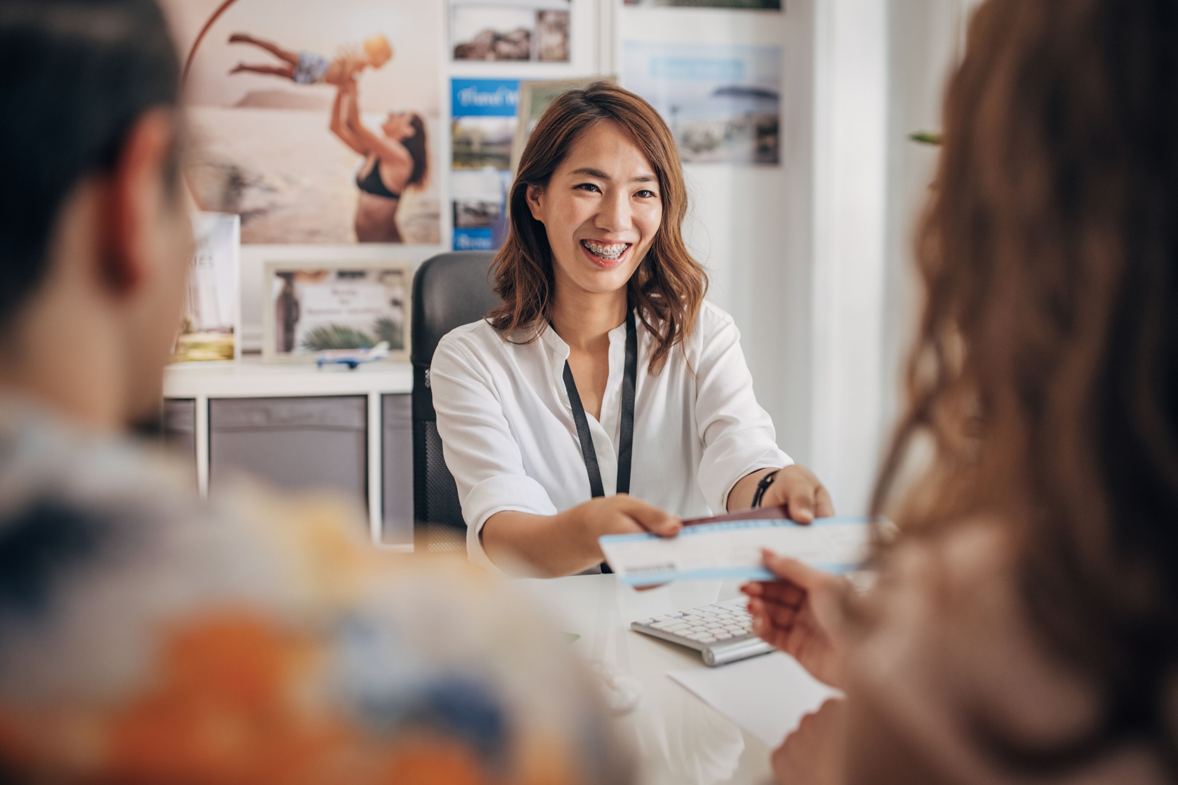 Travel Agent Handing Brochures to Clients