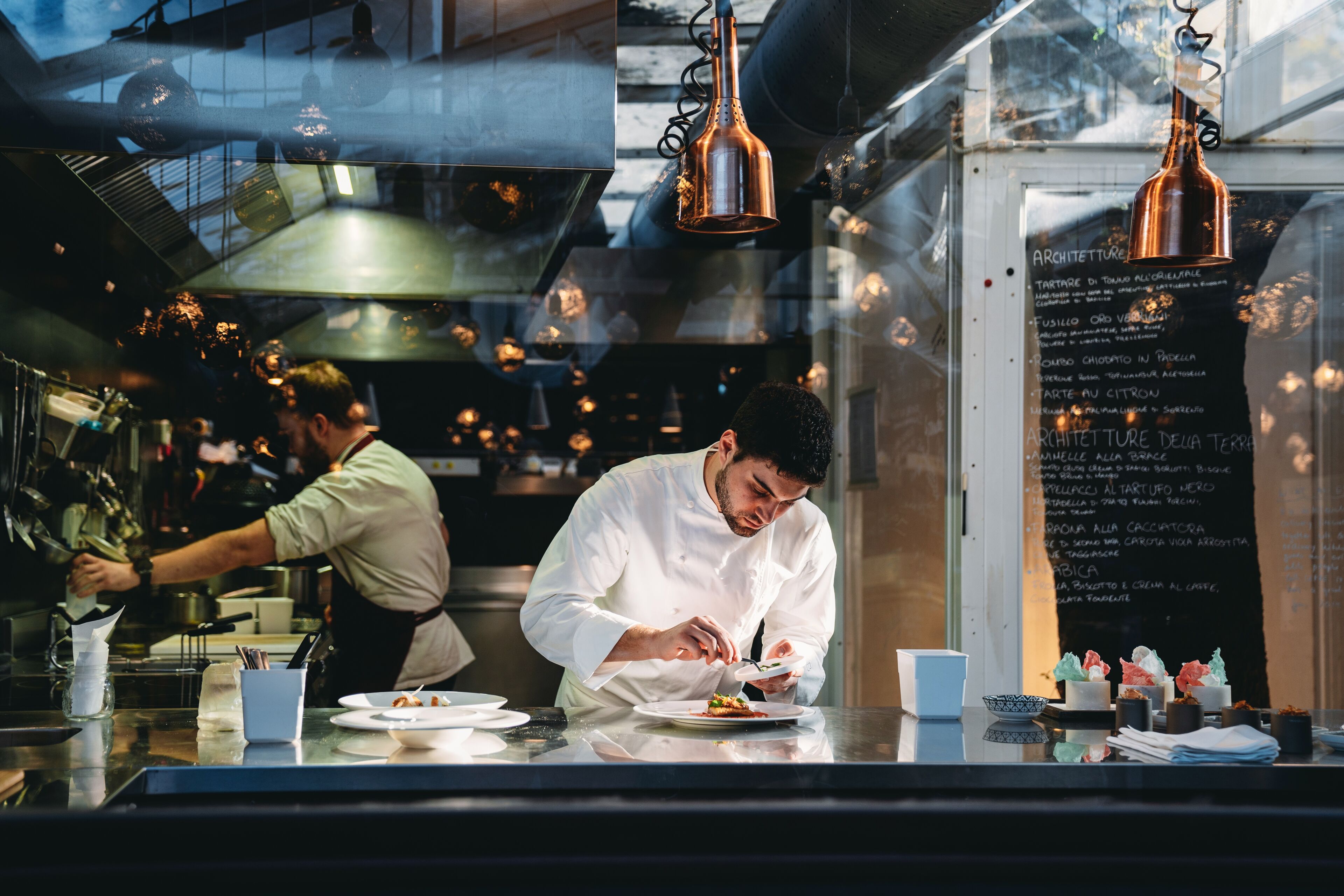 Chef Plating Dish in Restaurant Kitchen