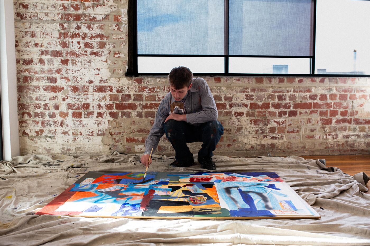 Artist Painting an Abstract Canvas in a Studio