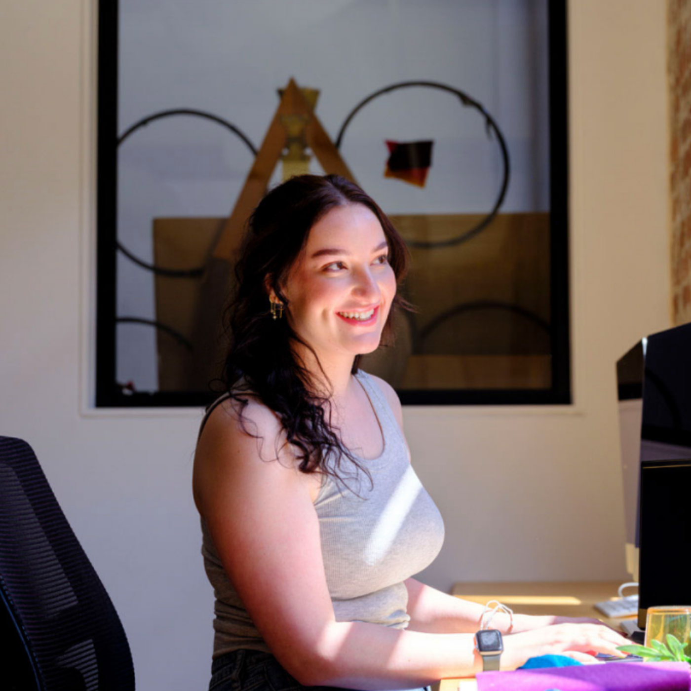 Smiling Woman Working at a Desk