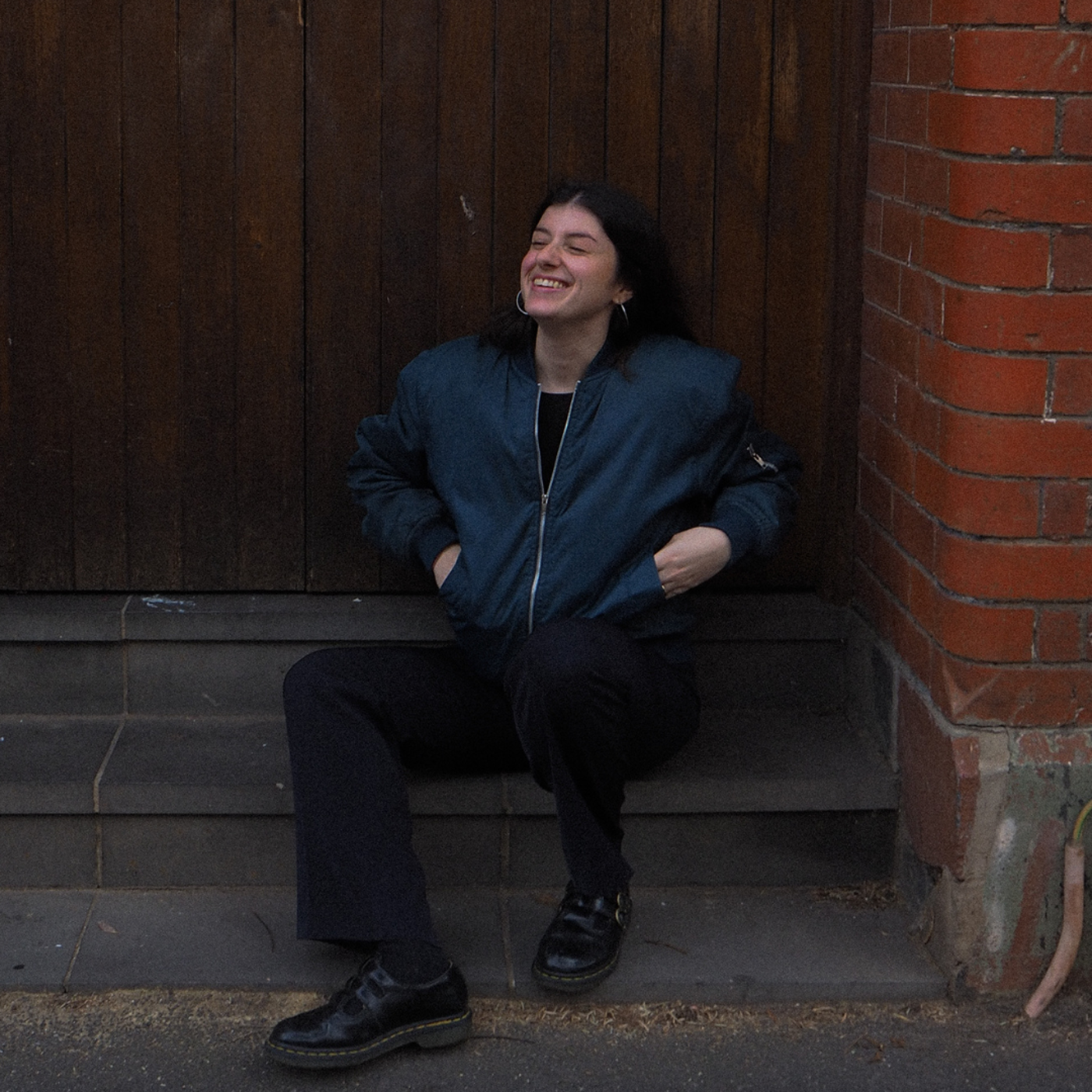 Smiling Woman Sitting on Outdoor Steps