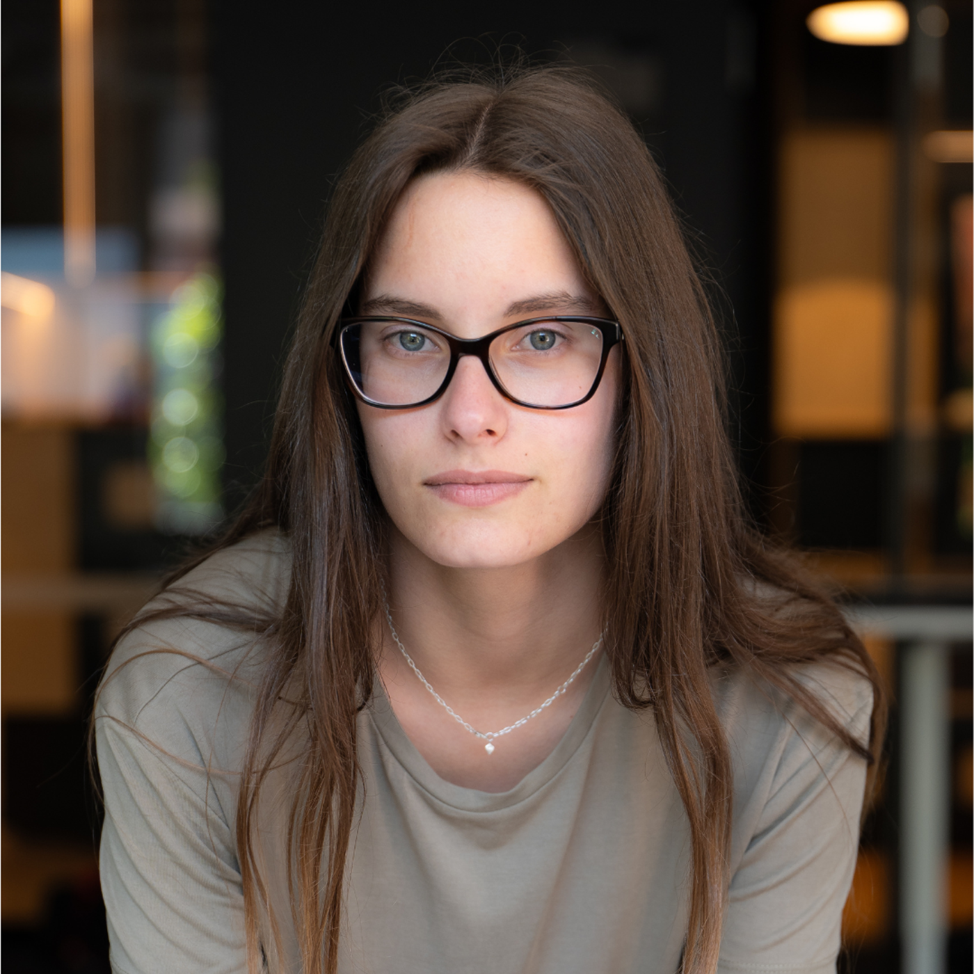 Young Woman with Glasses in a Modern Setting