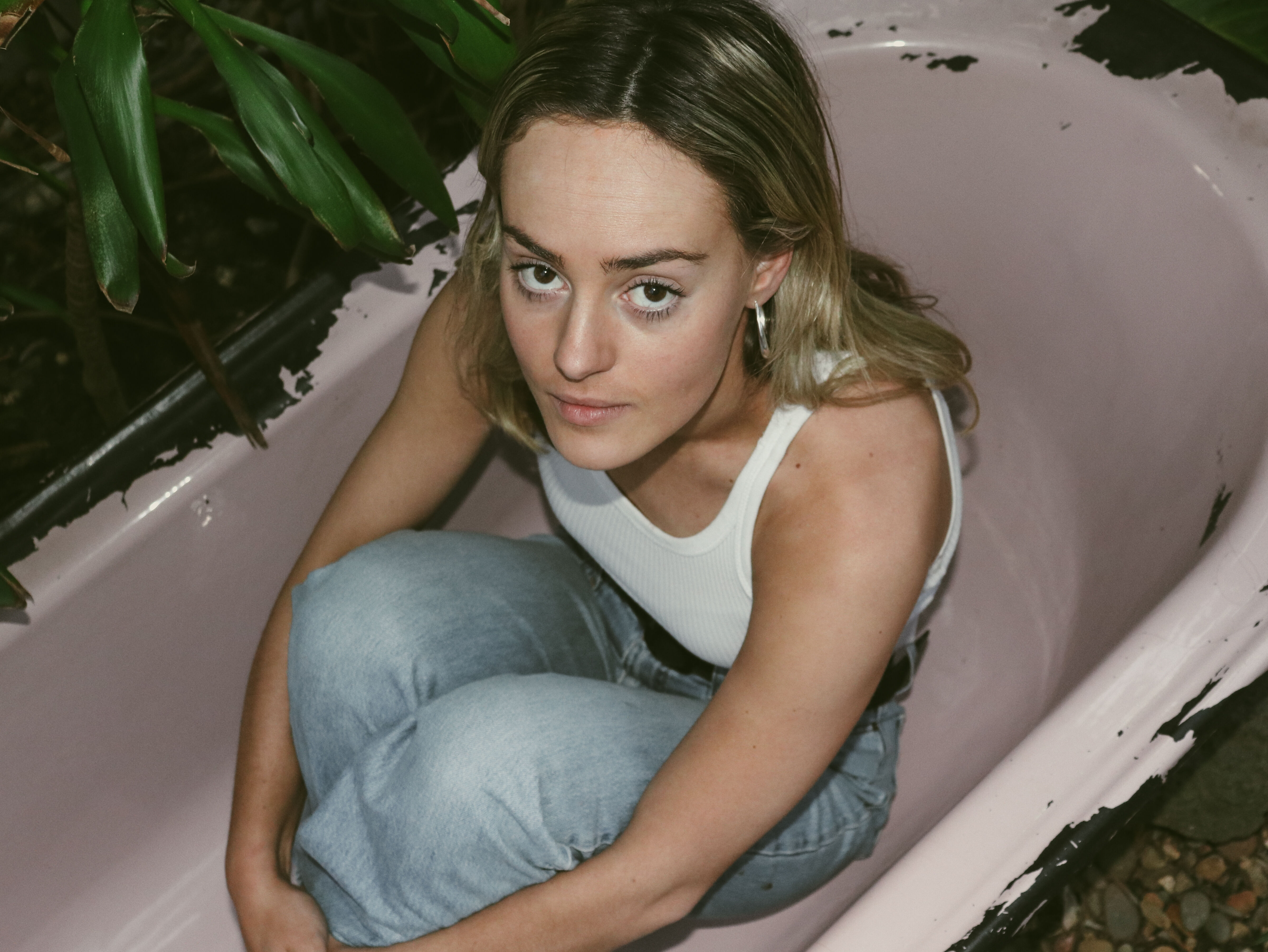 Contemplative Young Woman in Bathtub