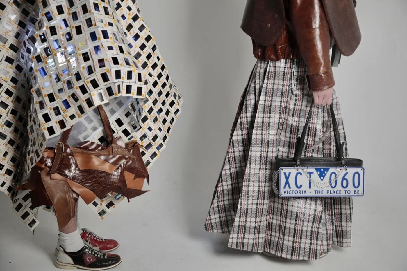 The image showcases two individuals with unique fashion choices. One wears a dress made of squares, while the other carries a license plate bag and a plaid skirt.