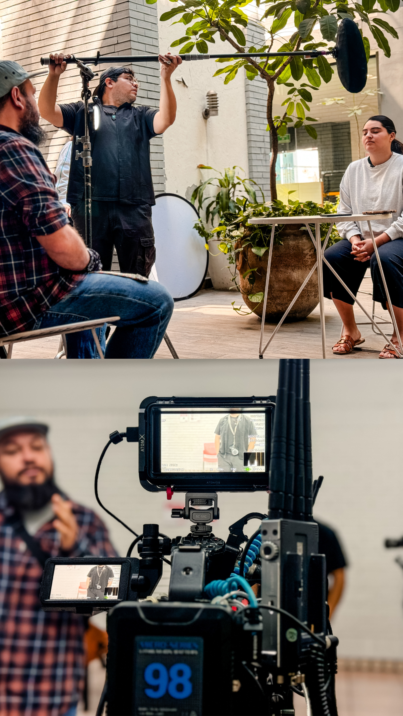 High-angle view of a film set showing a boom operator, two seated interviewees, and a camera setup with a monitor displaying a video feed.