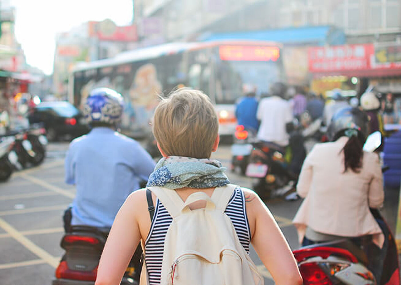 A traveler navigates the bustling streets of a vibrant city, immersed in the chaos and beauty of urban life.