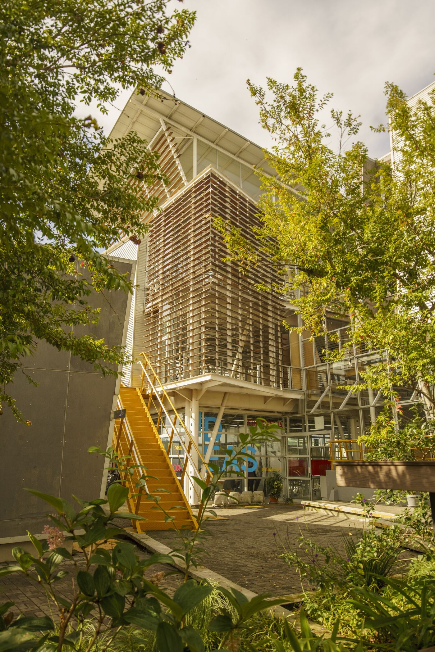 A sustainable building with vertical garden and solar panels integrates nature into urban architecture.