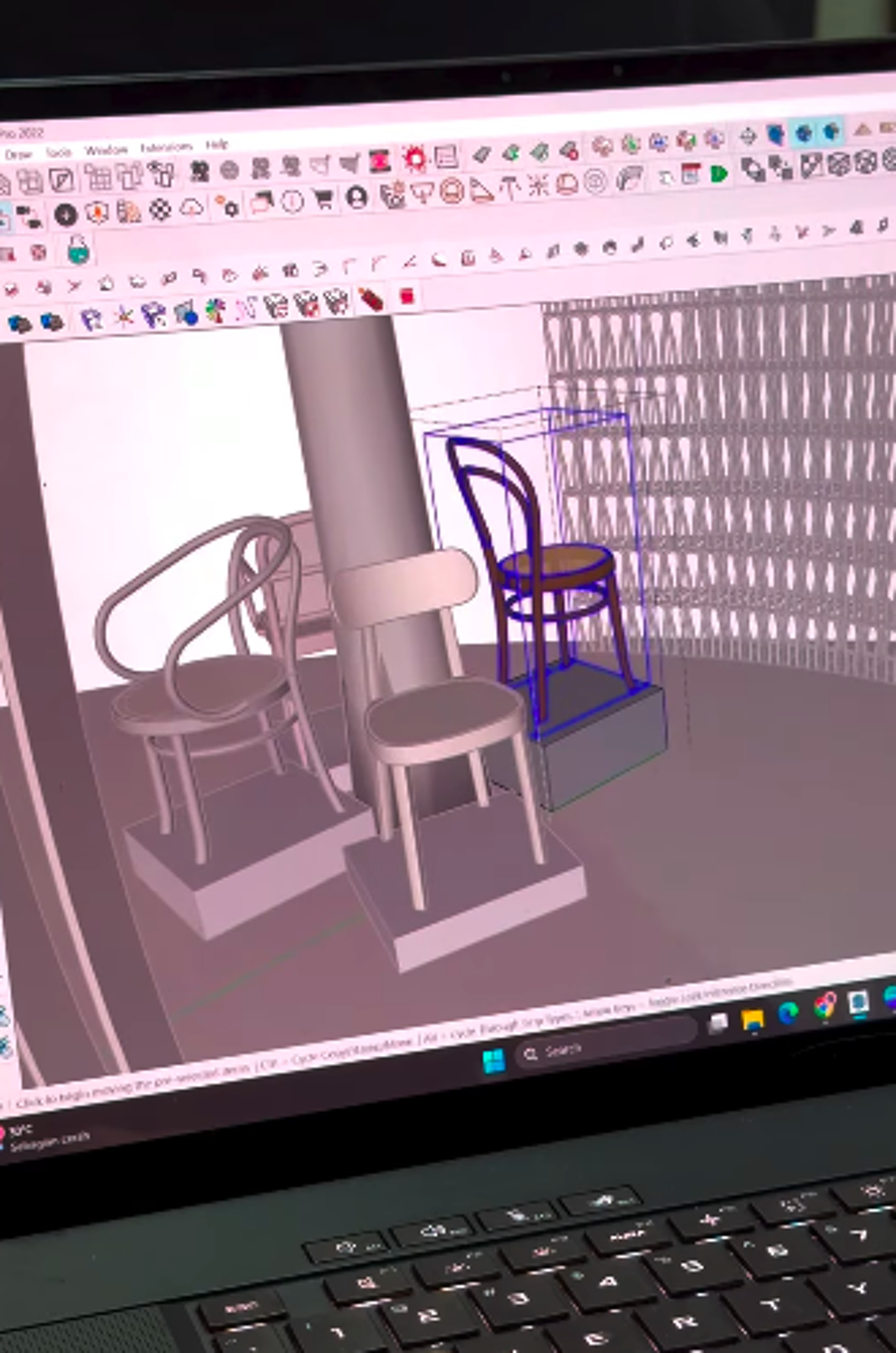 The image shows a laptop screen displaying a 3D modeling software, likely for interior design. Several chairs are rendered in the scene, some highlighted with a blue selection box, suggesting they are being edited or arranged within the virtual space.