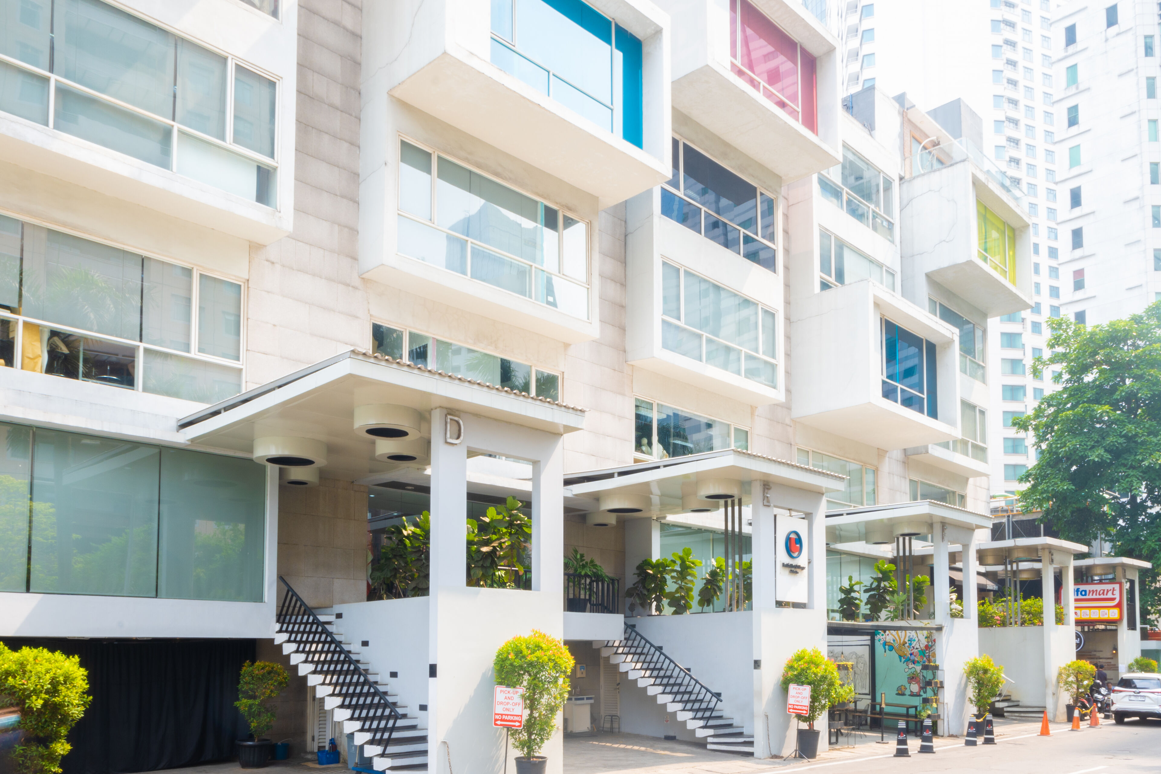 Contemporary architecture with balconies and vibrant colored accents on a bright sunny day.