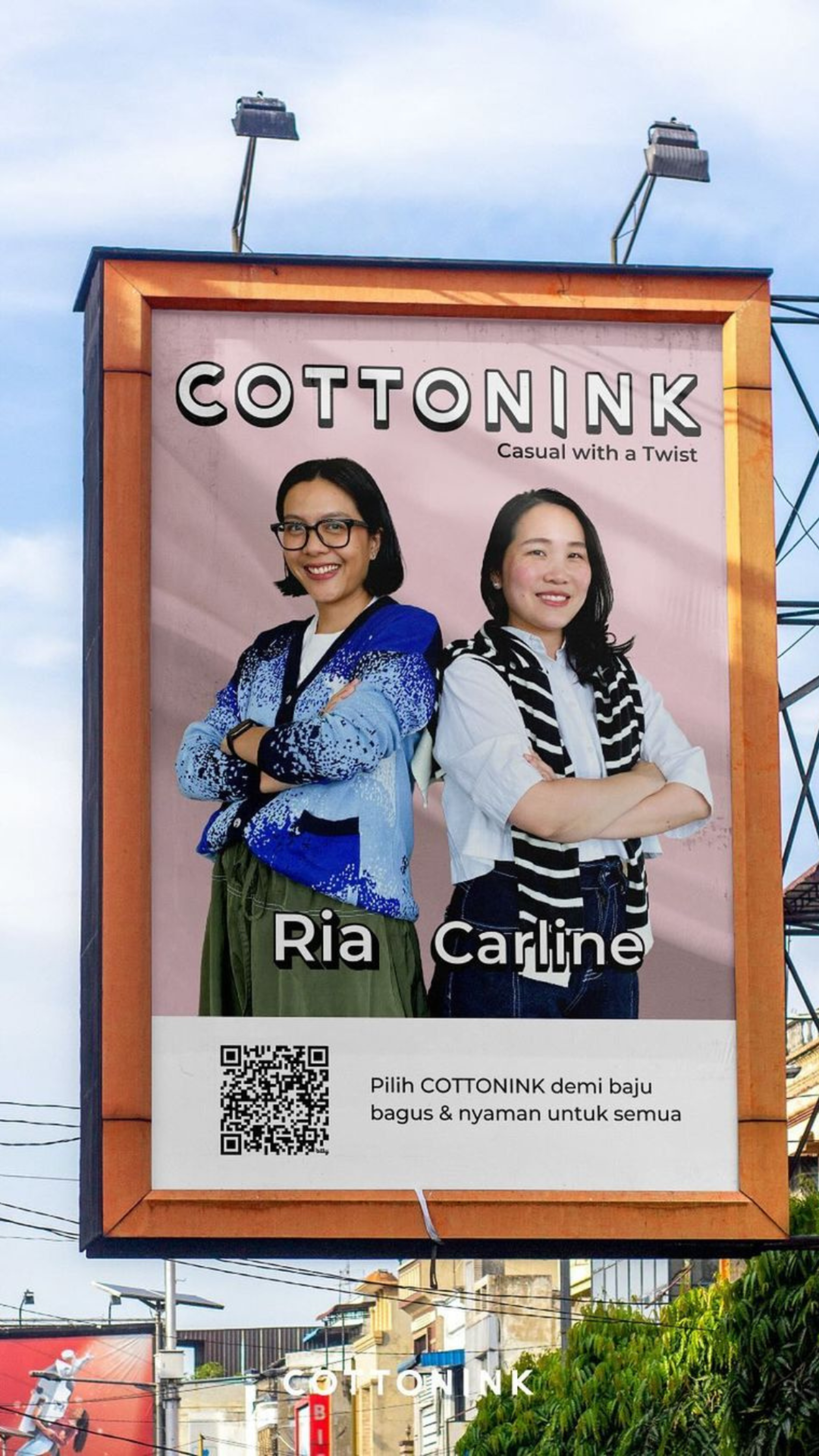 A billboard featuring two women modeling for COTTONINK, a fashion brand, with a slogan "Casual with a Twist".