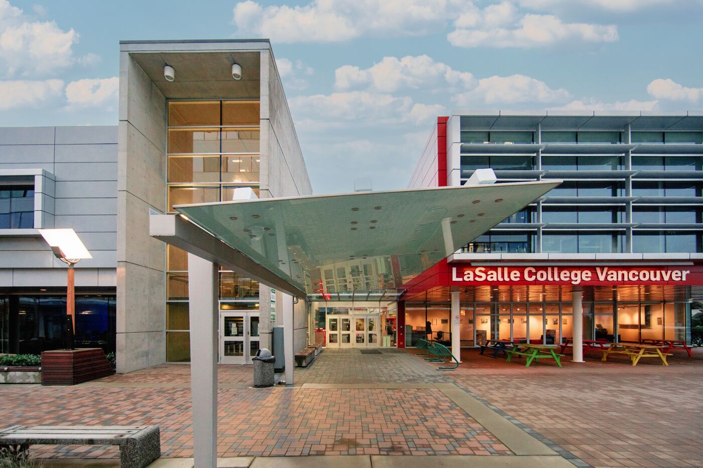 The modern entrance to LaSalle College Vancouver with a unique overhead structure at dusk.