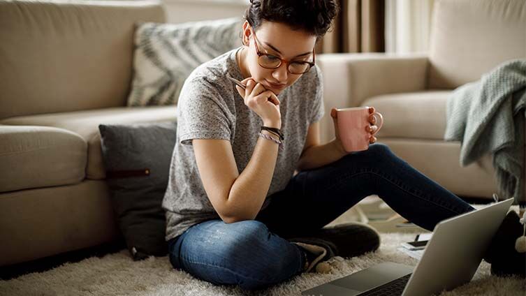 Woman Working on Laptop at Home