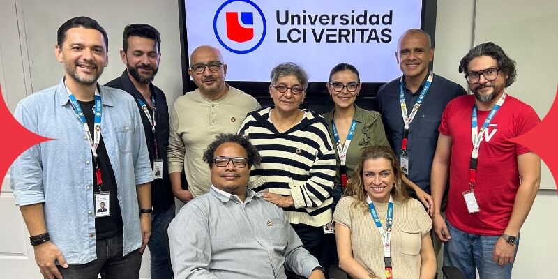 A diverse faculty team at Universidad LCI Veritas smiles for a group photo, showcasing collaboration and educational excellence.