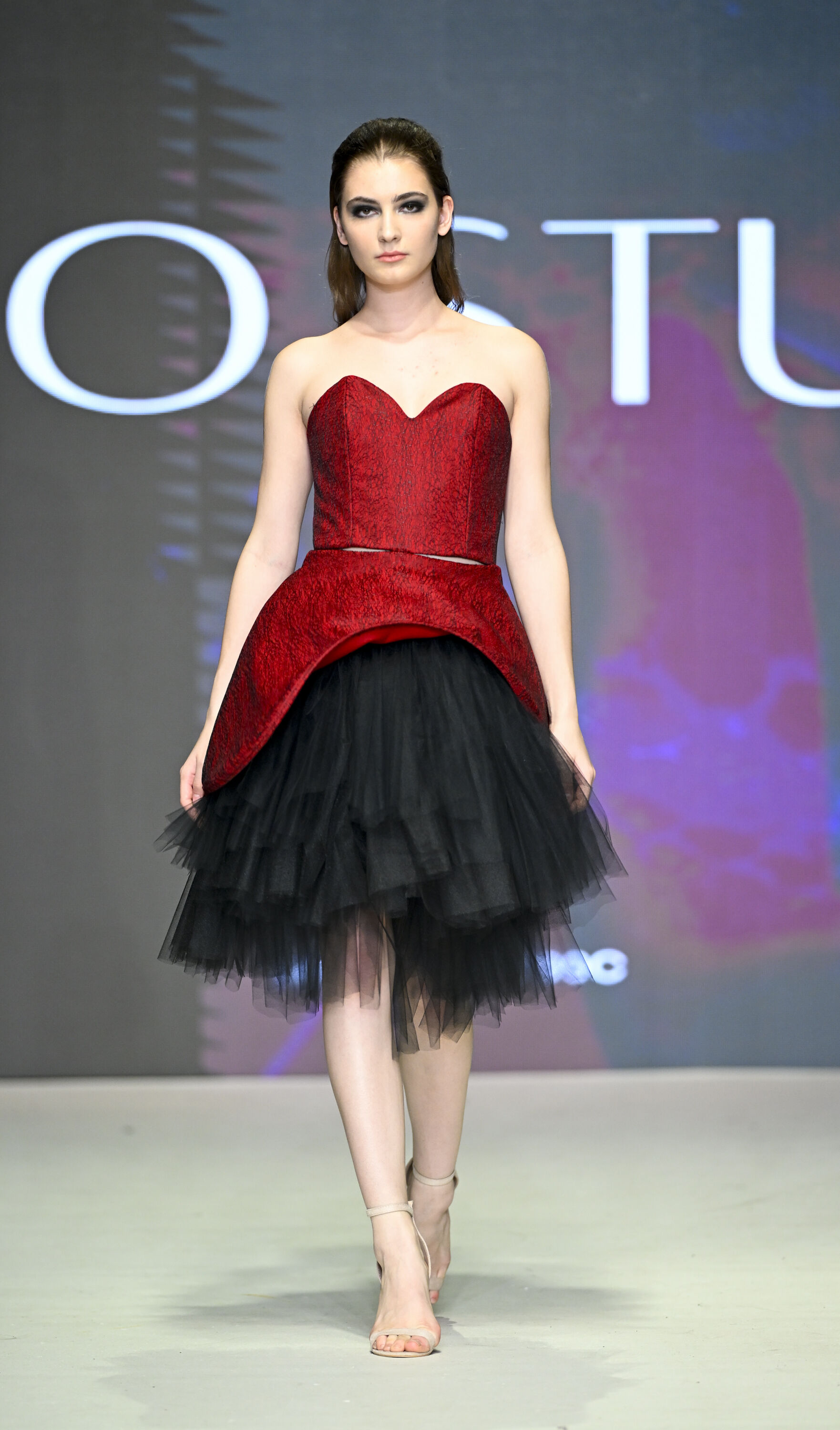 Model Showcasing Bold Red and Black Tulle Gown