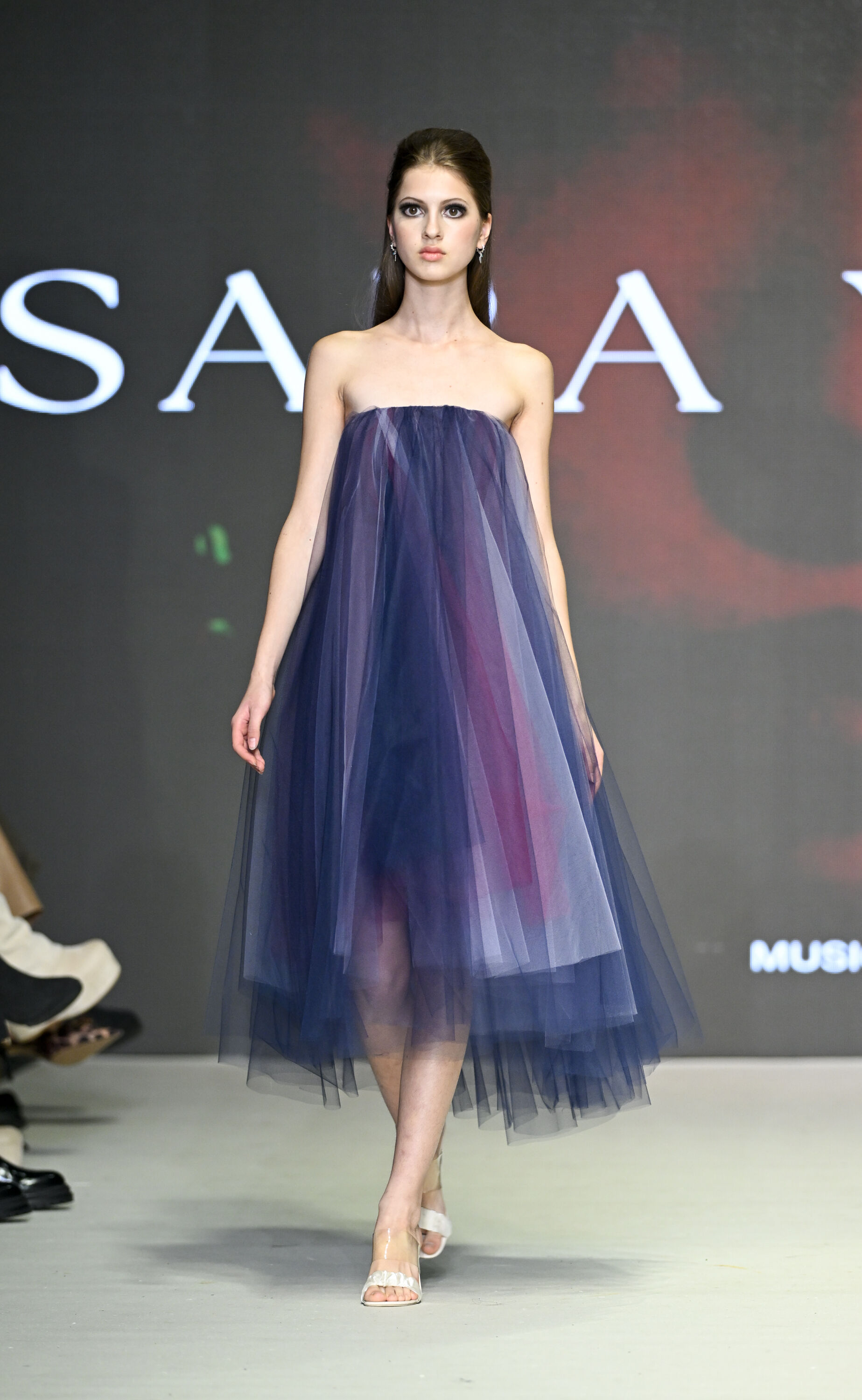 Model Wearing Elegant Strapless Tulle Dress on Runway