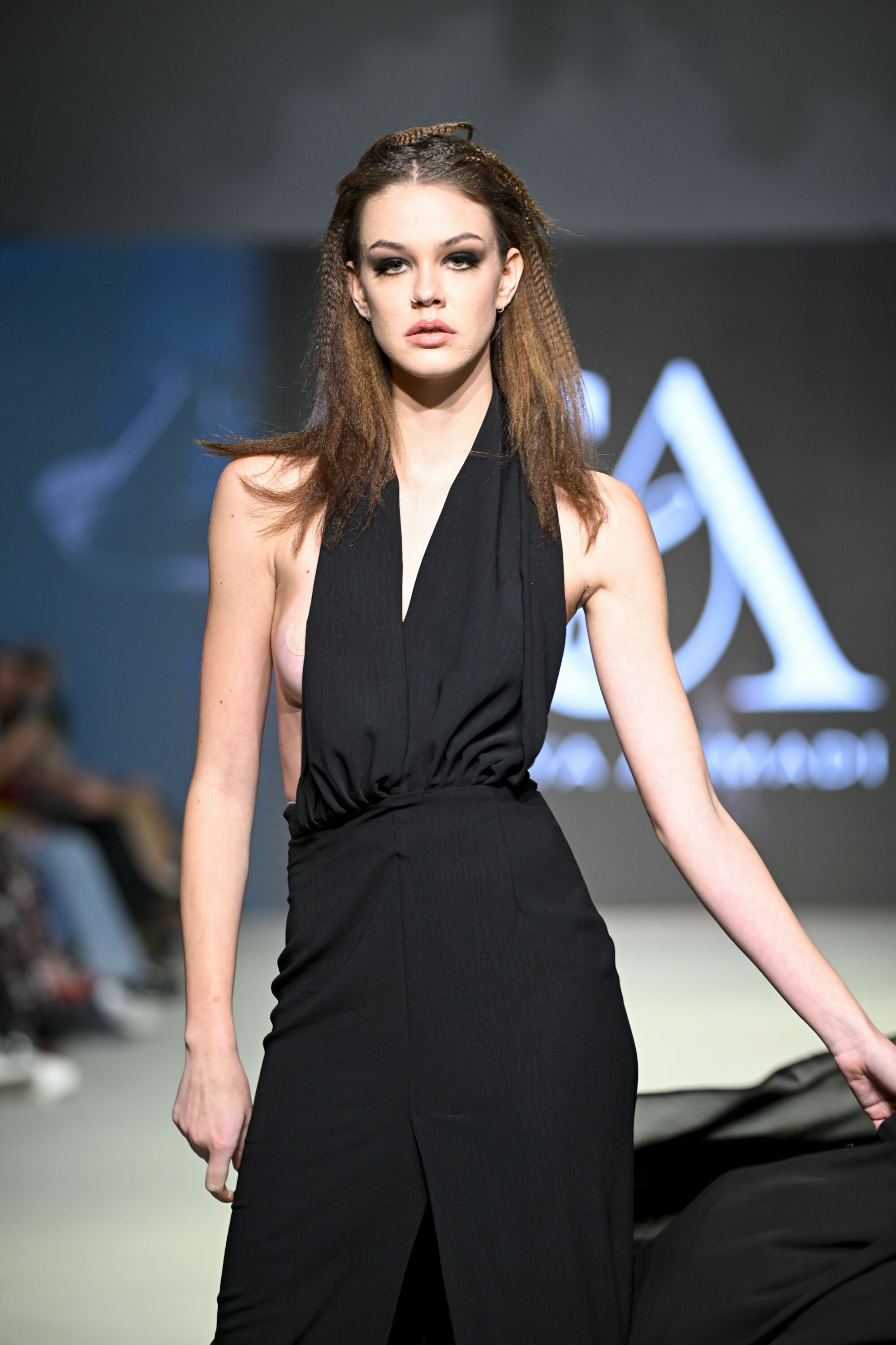 Model in Sophisticated Black Evening Gown on Runway