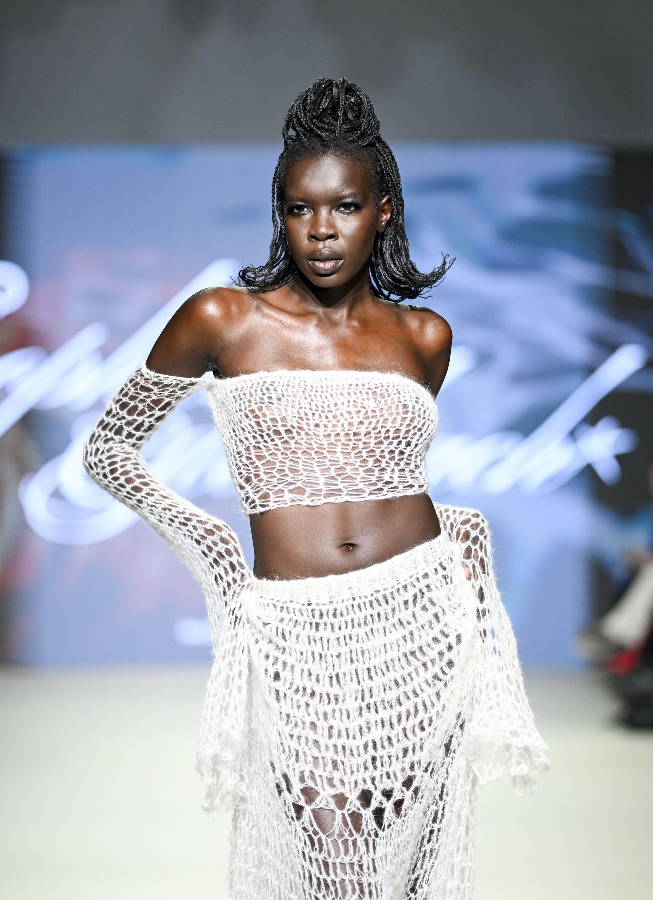 Model Showcasing Crochet-Inspired Fashion on Runway